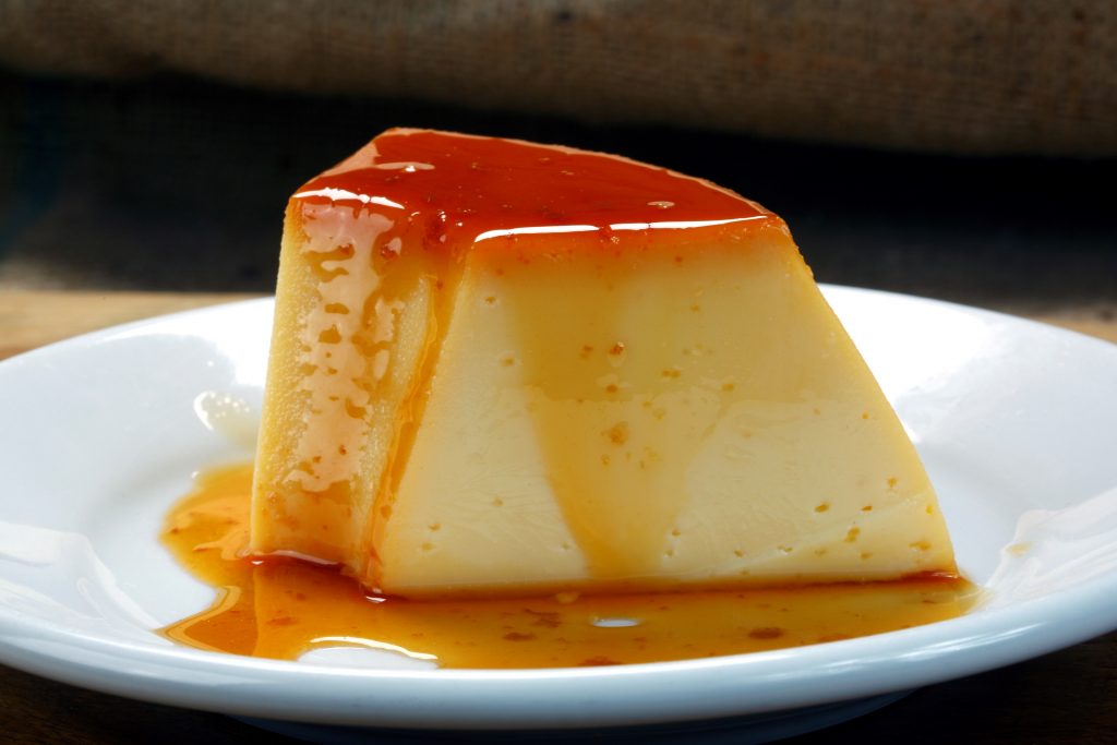 Photo of slice of Mexican flan on a plate.