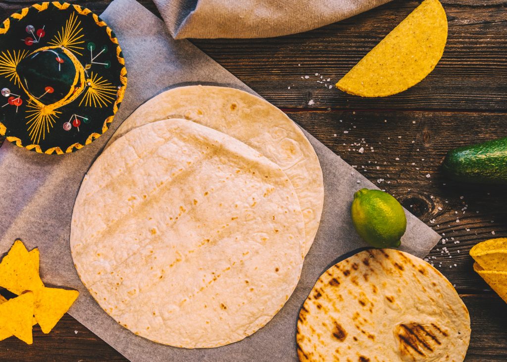 Photo of corn tortilla and flour tortilla illustrates blog: "What Type of Tortilla To Use for Birria Tacos?"