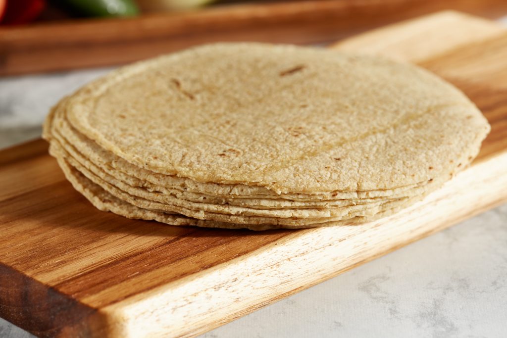 Photo of tortillas on chopping board illustrates blog: "Can Tortillas Be Frozen?"