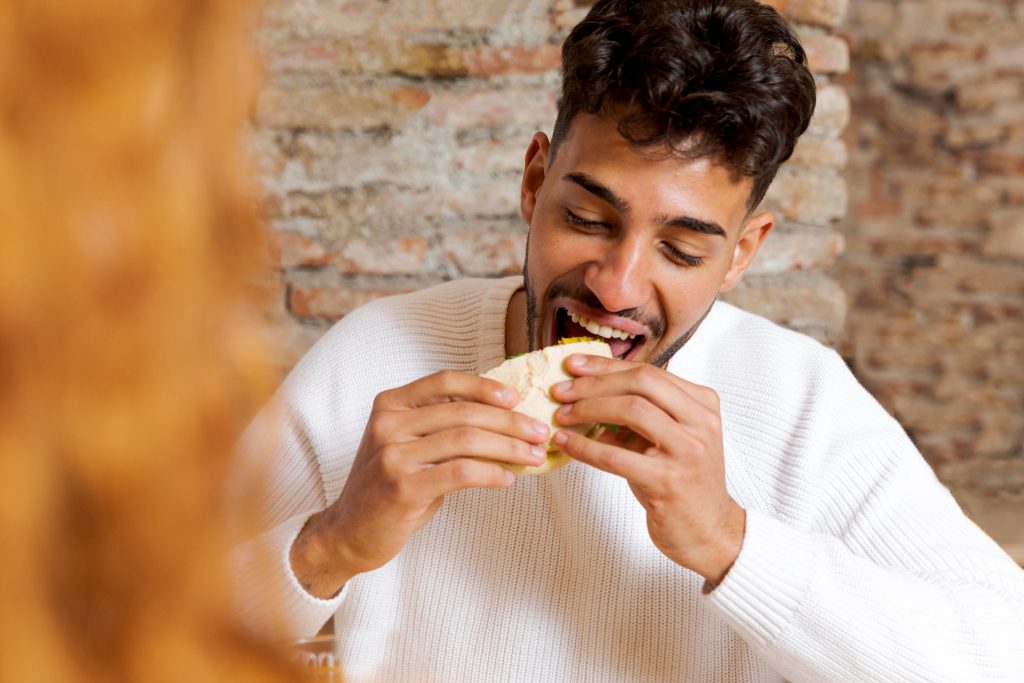 Man eating illustrates blog "How Are You Supposed To Eat Carnitas?"