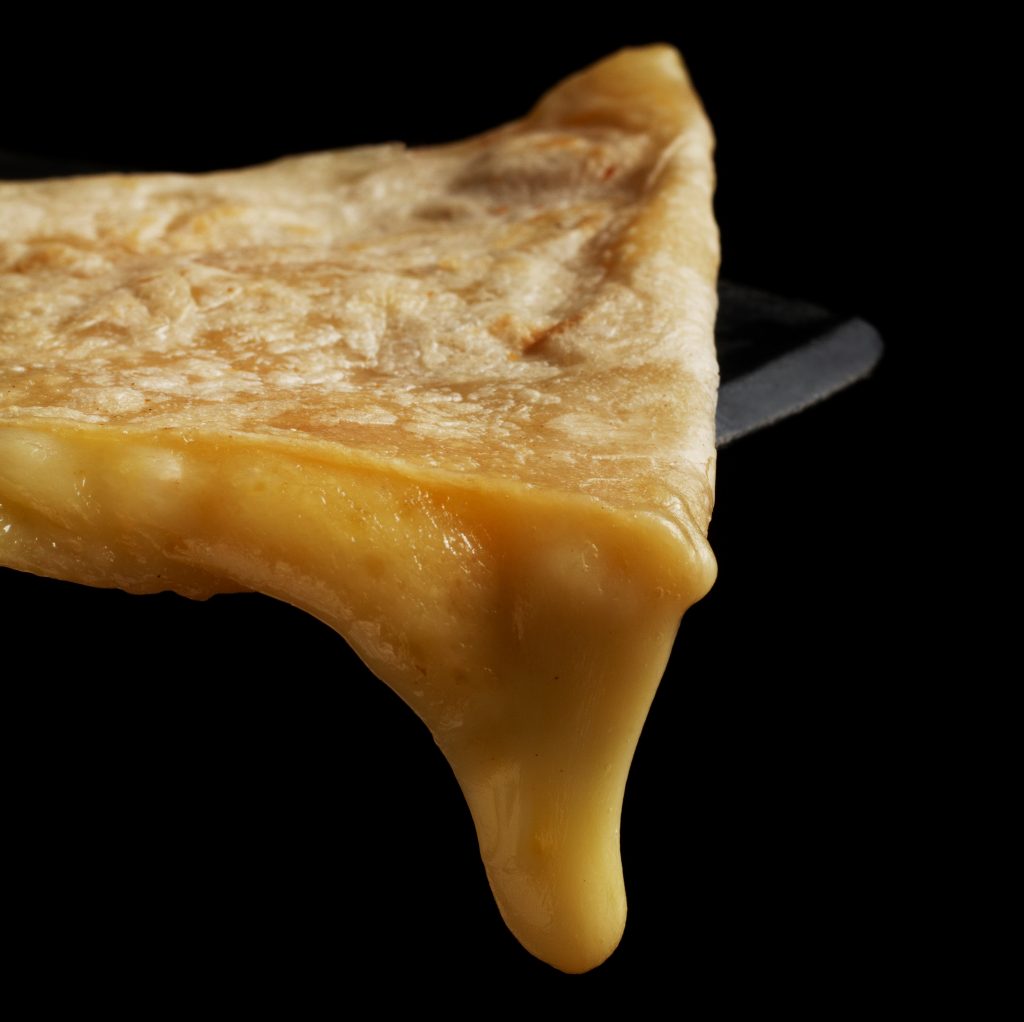 Photo of quesadilla dripping melting cheese.