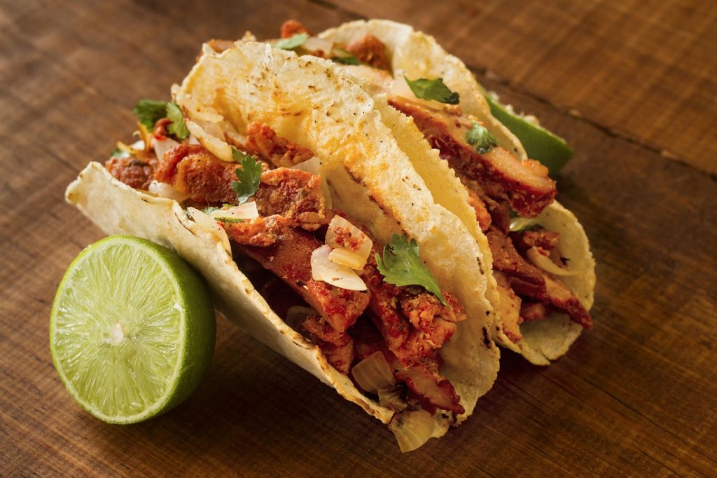 Closeup of two tacos al pastor.