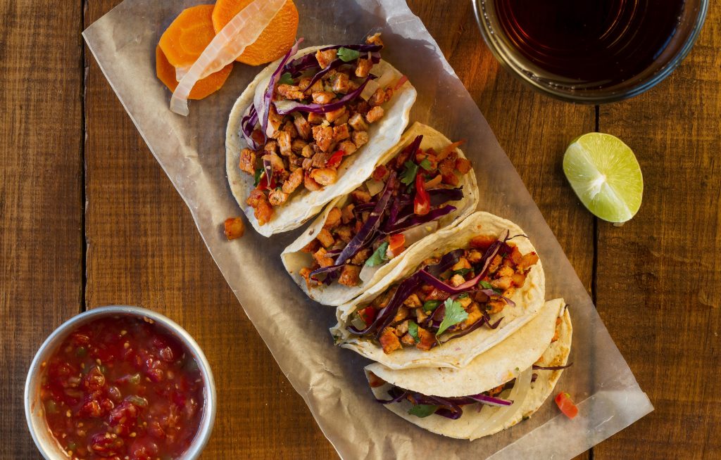 Four tacos seen from above illustrate blog "Mexican Food vs Italian Food: Which One Is Best?"