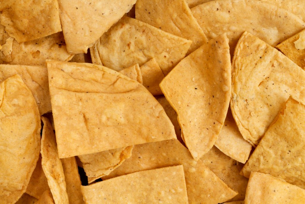 Closeup of tortilla chips illustrates blog "Are Totopos and Tortilla Chips the Same?"